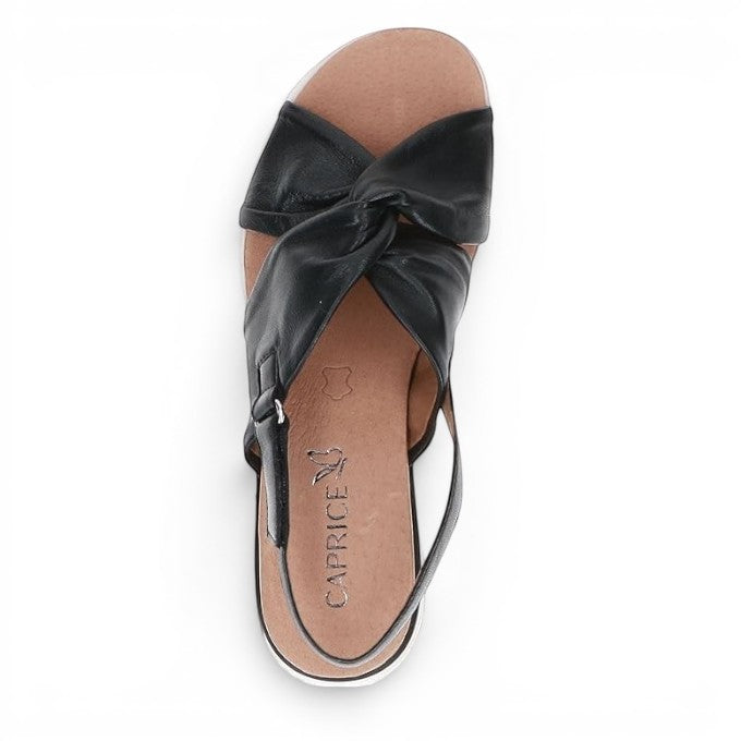 ShoeShop Caprice black leather sandals with a twisted strap design and comfortable tan cushioned insole.