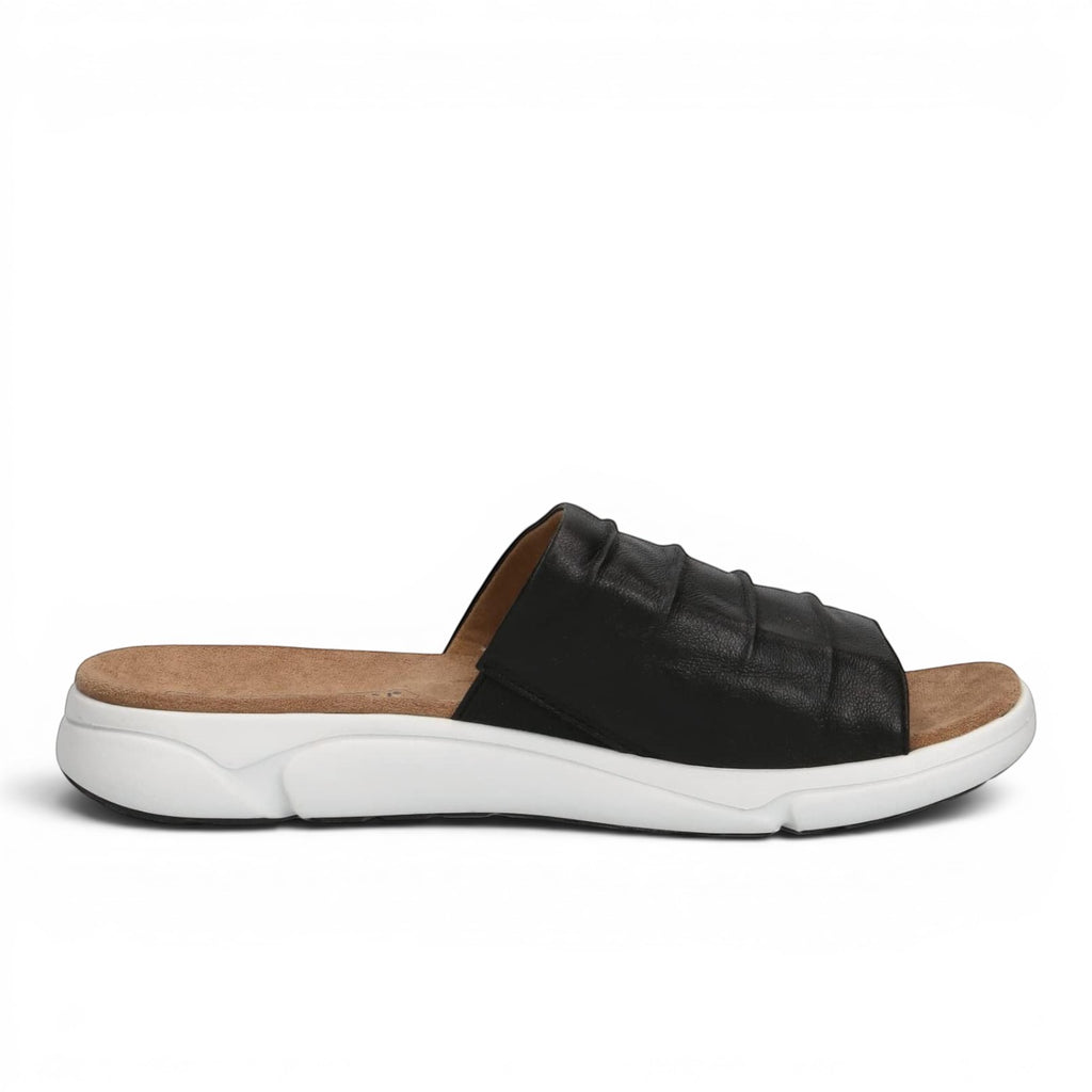 ShoeShop Caprice black leather slide sandals with a comfortable tan footbed and a thick white athletic sole.