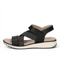 ShoeShop Caprice black strappy sandals with elastic cross-straps and a comfortable white platform sole.