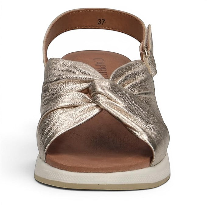 ShoeShop Caprice metallic gold leather sandals with a twisted front strap and adjustable slingback heel strap.