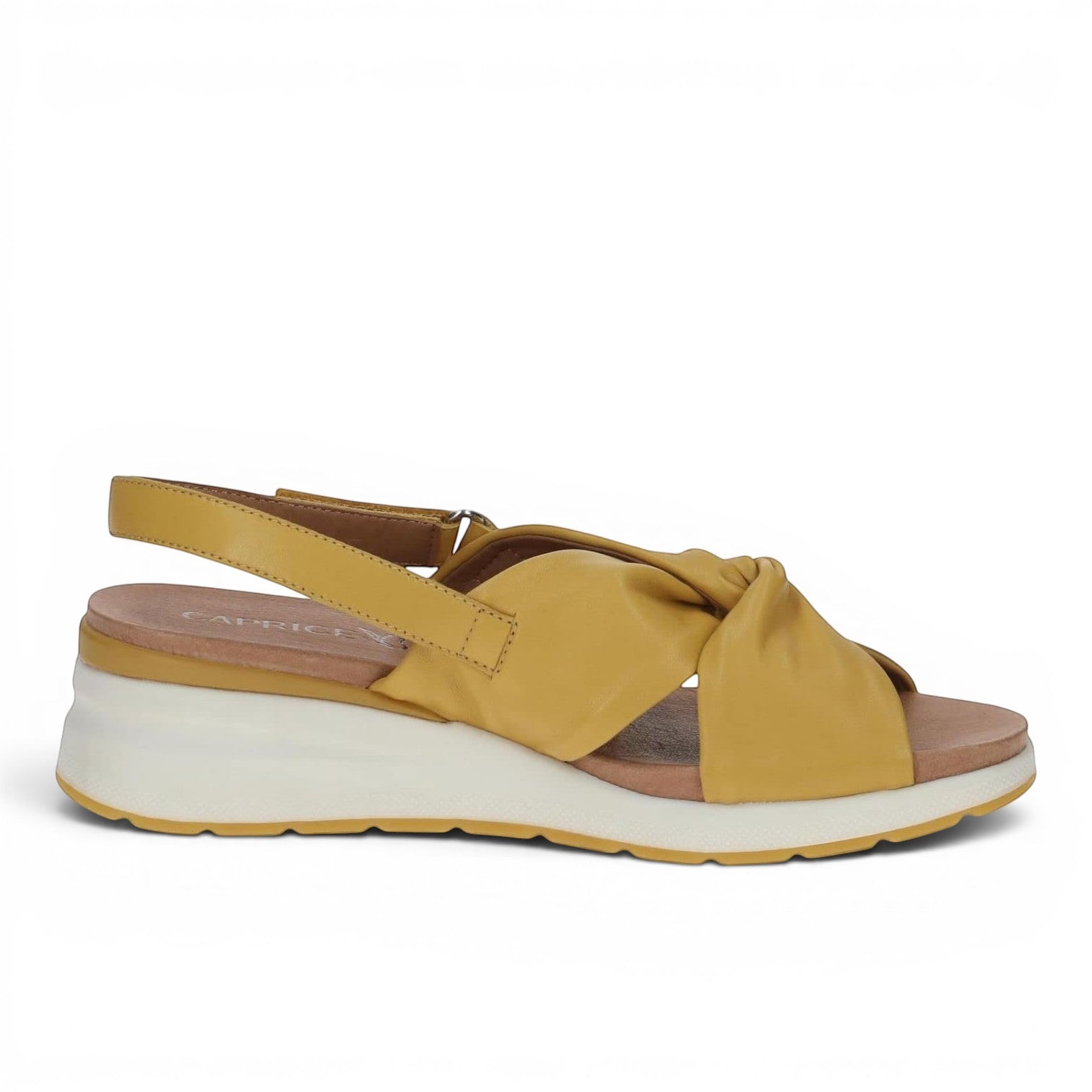 ShoeShop Caprice mustard yellow leather wedge sandals with a knotted front strap and adjustable slingback closure.