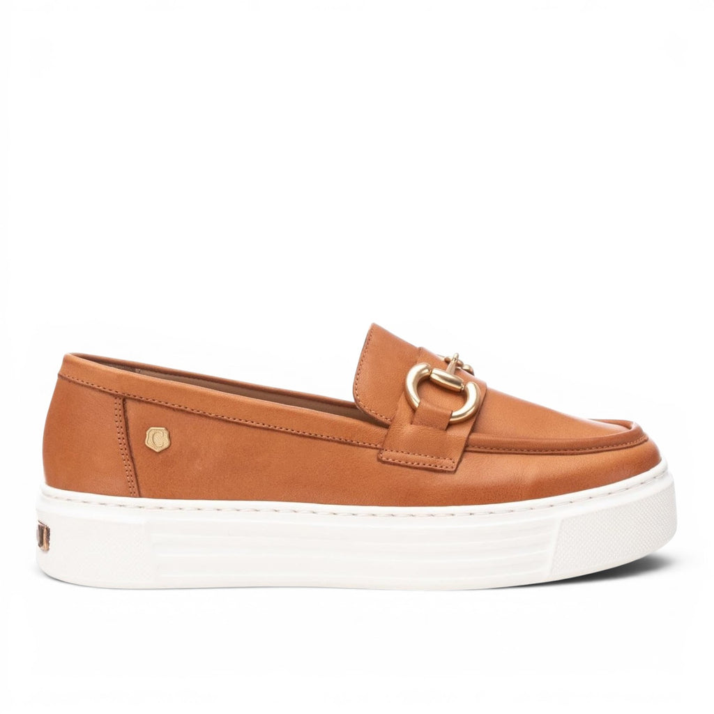 ShoeShop Carmela 161319 tan leather loafers with a gold metal bit detail and a chunky white platform sole.