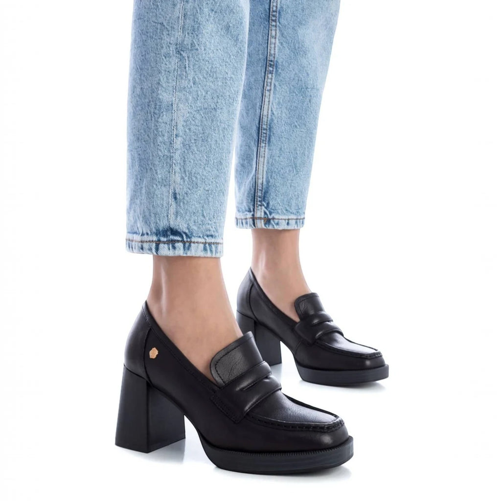 ShoeShop Carmela 161218 black leather loafers with a chunky block heel and platform sole worn with light blue jeans.