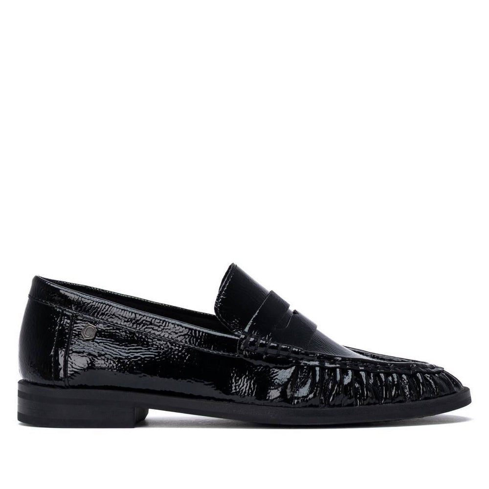 ShoeShop Carmela black patent leather loafers with a classic penny strap design and durable rubber sole.