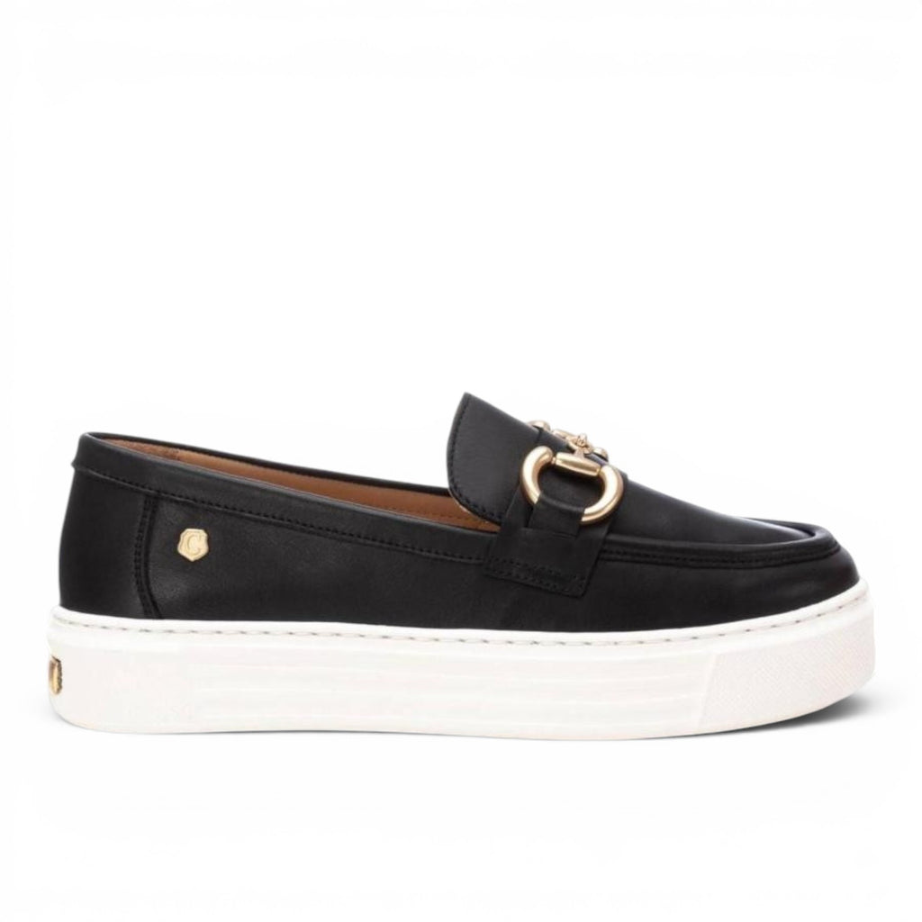 ShoeShop Carmela 161319 black leather platform loafers with gold-tone metal horsebit detail and white rubber sole.