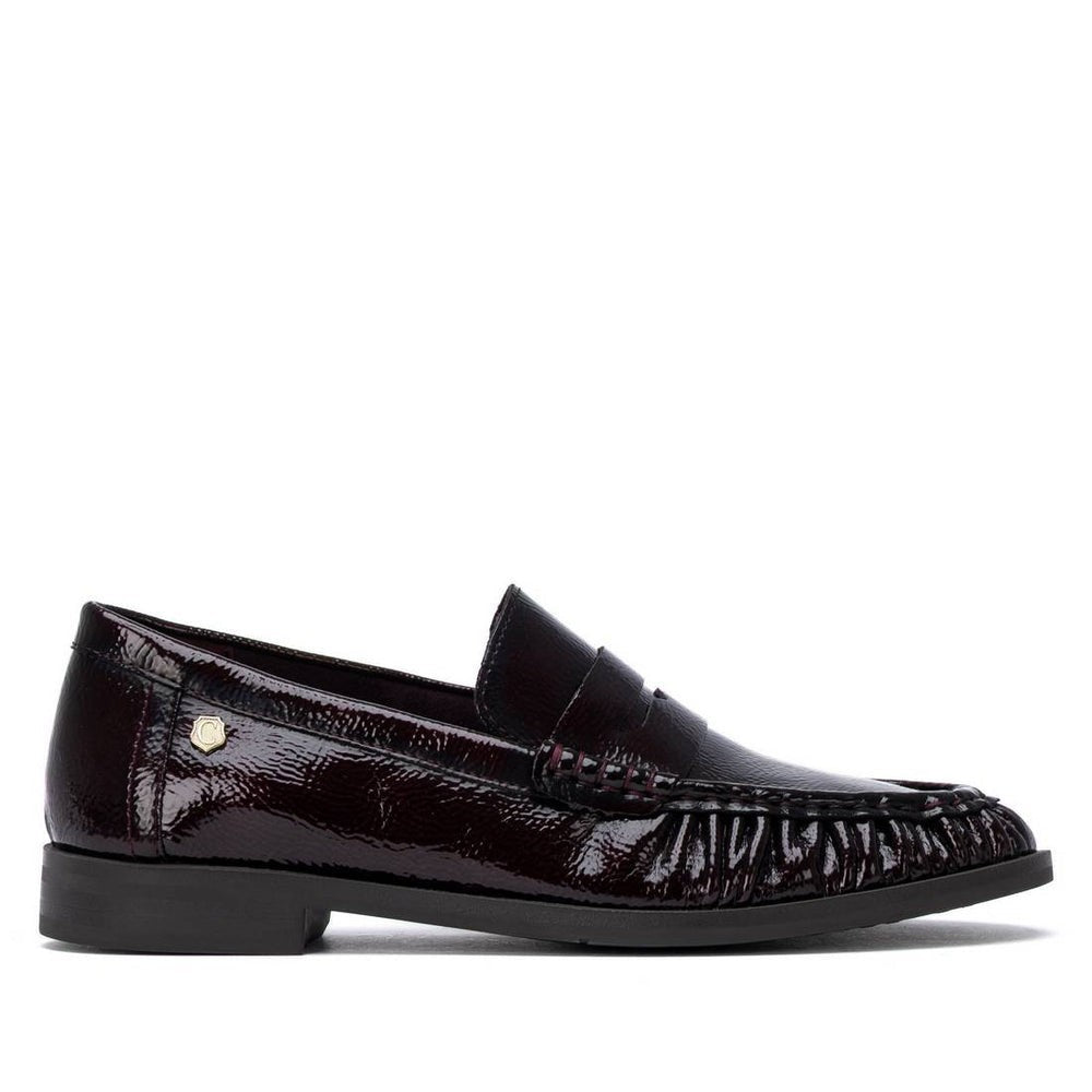 ShoeShop Carmela 164357 dark burgundy patent leather loafers with a decorative front detail and durable rubber sole.