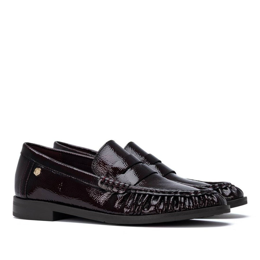 ShoeShop Carmela dark burgundy patent leather loafers with decorative stitching and a durable rubber sole.