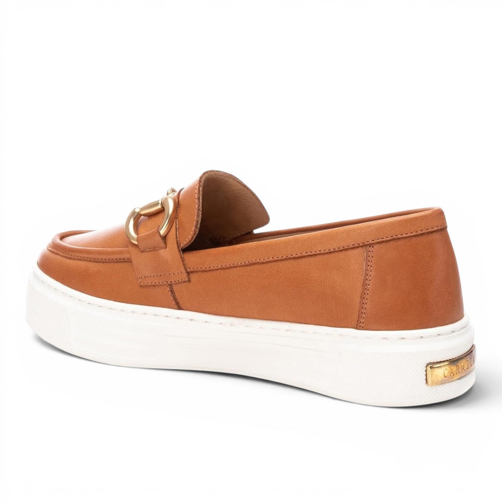 ShoeShop Carmela 161319 tan leather loafers with a gold-tone metal bit detail and a thick white platform sole.