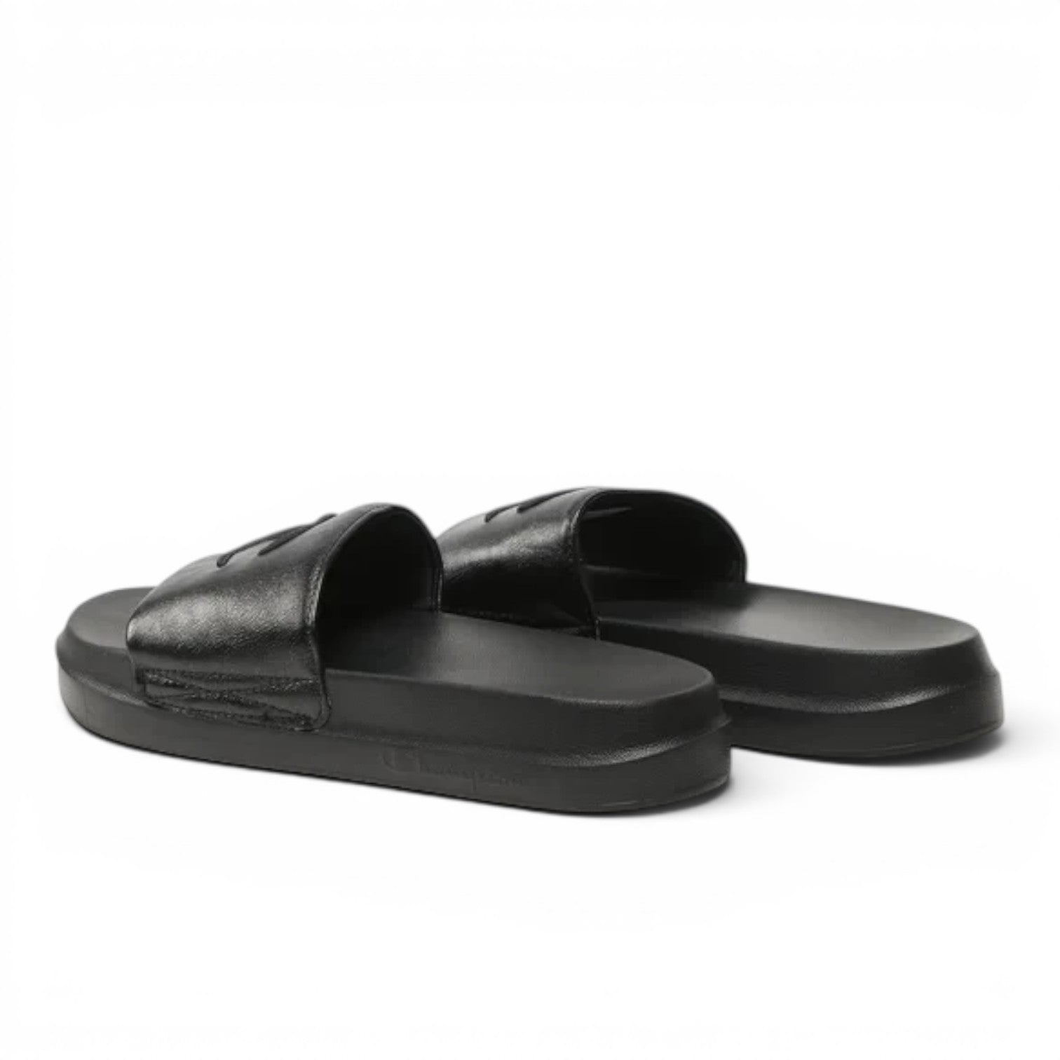 ShoeShop Champion S11561 black slip-on sandals with a wide strap and embossed logo on a comfortable flat sole.