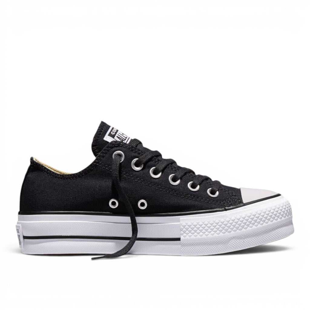 ShoeShop Converse 560250C black canvas low-top platform sneakers with white rubber sole and silver eyelets.