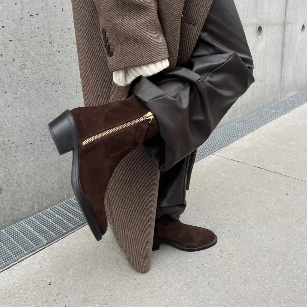 ShoeShop Copenhagen dark brown suede ankle boots with gold side zipper and 5cm heel worn with brown trousers