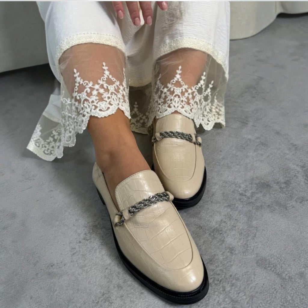 ShoeShop Copenhagen CS7966 beige crocodile-embossed leather loafers with a decorative silver chain detail.