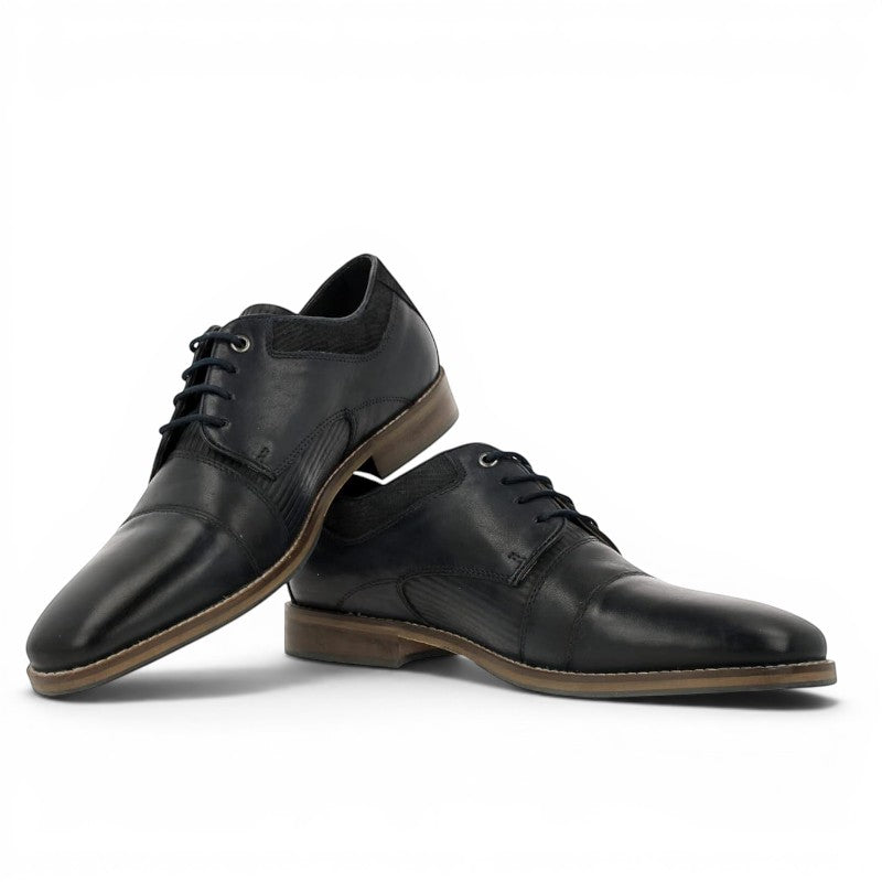 ShoeShop dark blue leather cap toe oxford shoes with textured accents and brown soles.