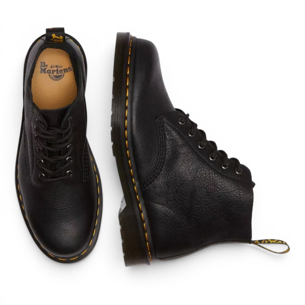 ShoeShop Dr. Martens 101 Ambassador black leather ankle boots with yellow welt stitching and lace-up closure.