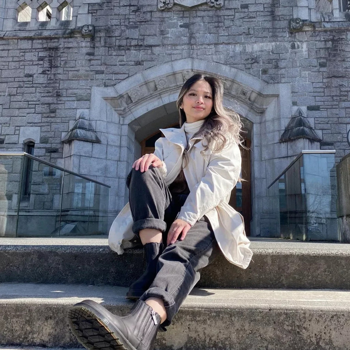 ShoeShop Dr. Martens 2976 Alyson black leather Chelsea boots with Wintergrip soles worn by a woman on stone steps.