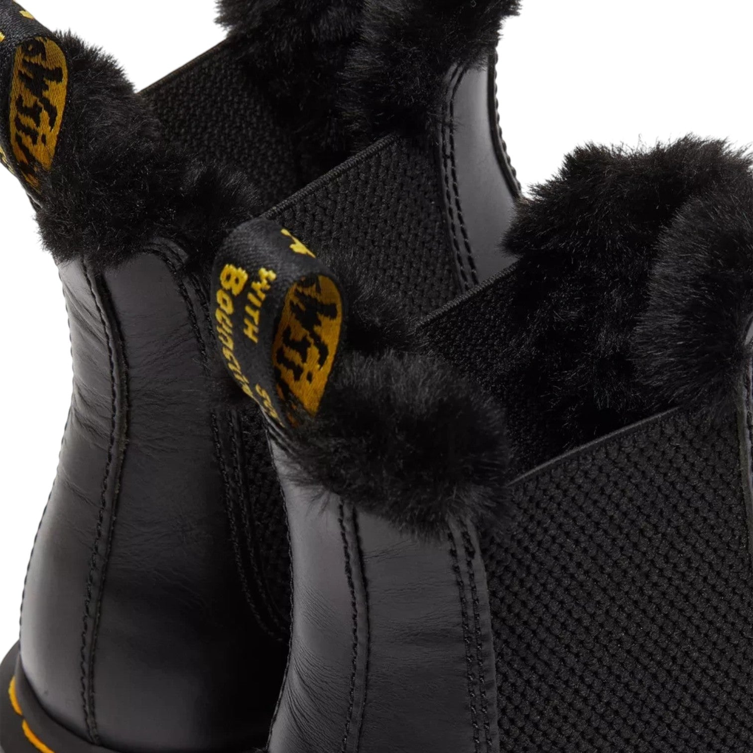 ShoeShop Dr. Martens black leather Chelsea boots with faux fur lining and iconic yellow heel pull tab