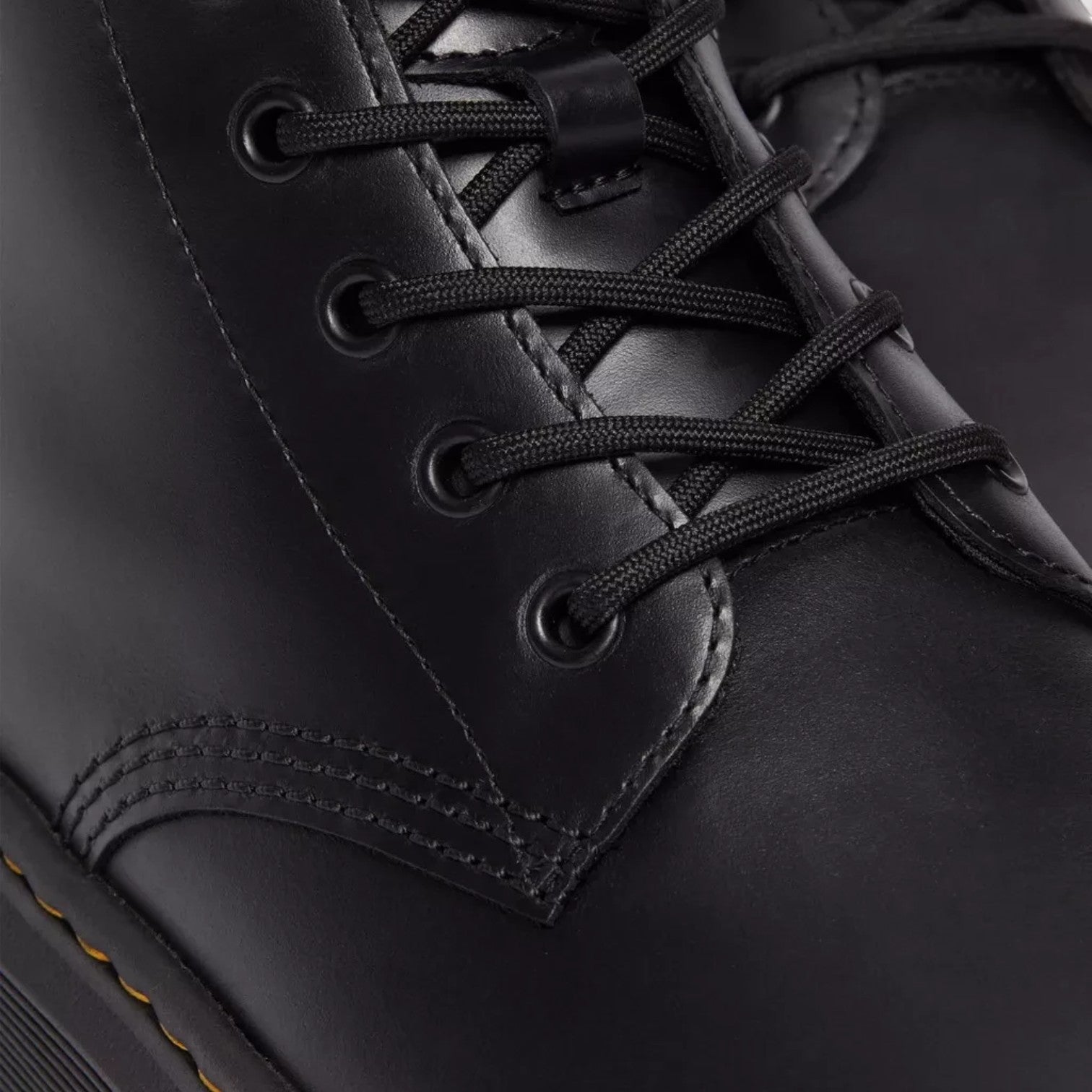 ShoeShop Dr. Martens black leather lace-up boots with signature yellow welt stitching and black eyelets