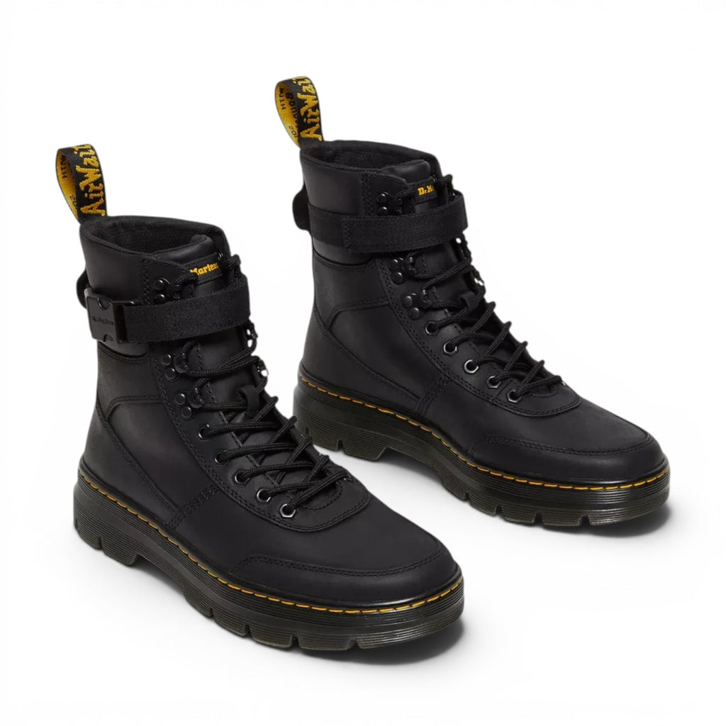 ShoeShop Dr. Martens Combs Tech II black Wyoming leather utility boots with ankle strap and yellow welt stitching.