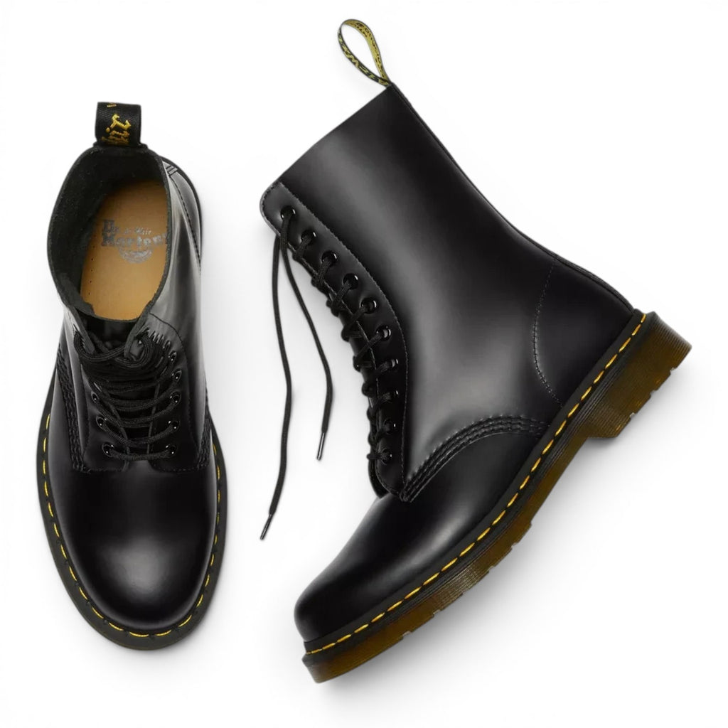 ShoeShop Dr. Martens 11857001 black patent leather boots with iconic yellow stitching and air-cushioned PVC soles.