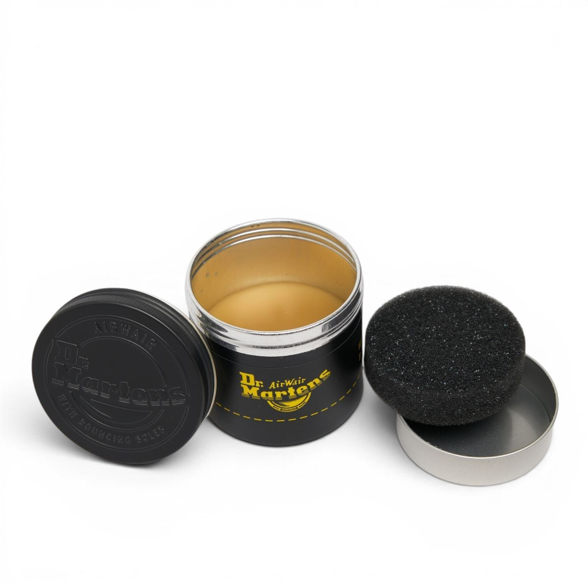 ShoeShop Dr. Martens Wonder Balsam leather conditioner in a black tin with an included black sponge applicator.