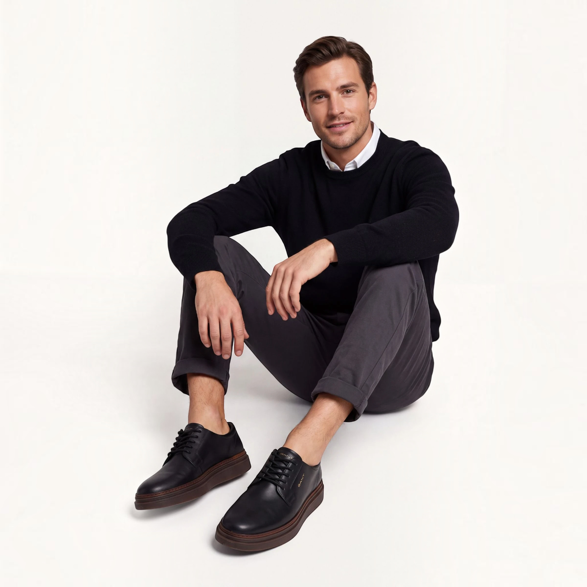 ShoeShop GANT black leather lace-up shoes with rubber soles worn by a man in a black sweater and grey trousers