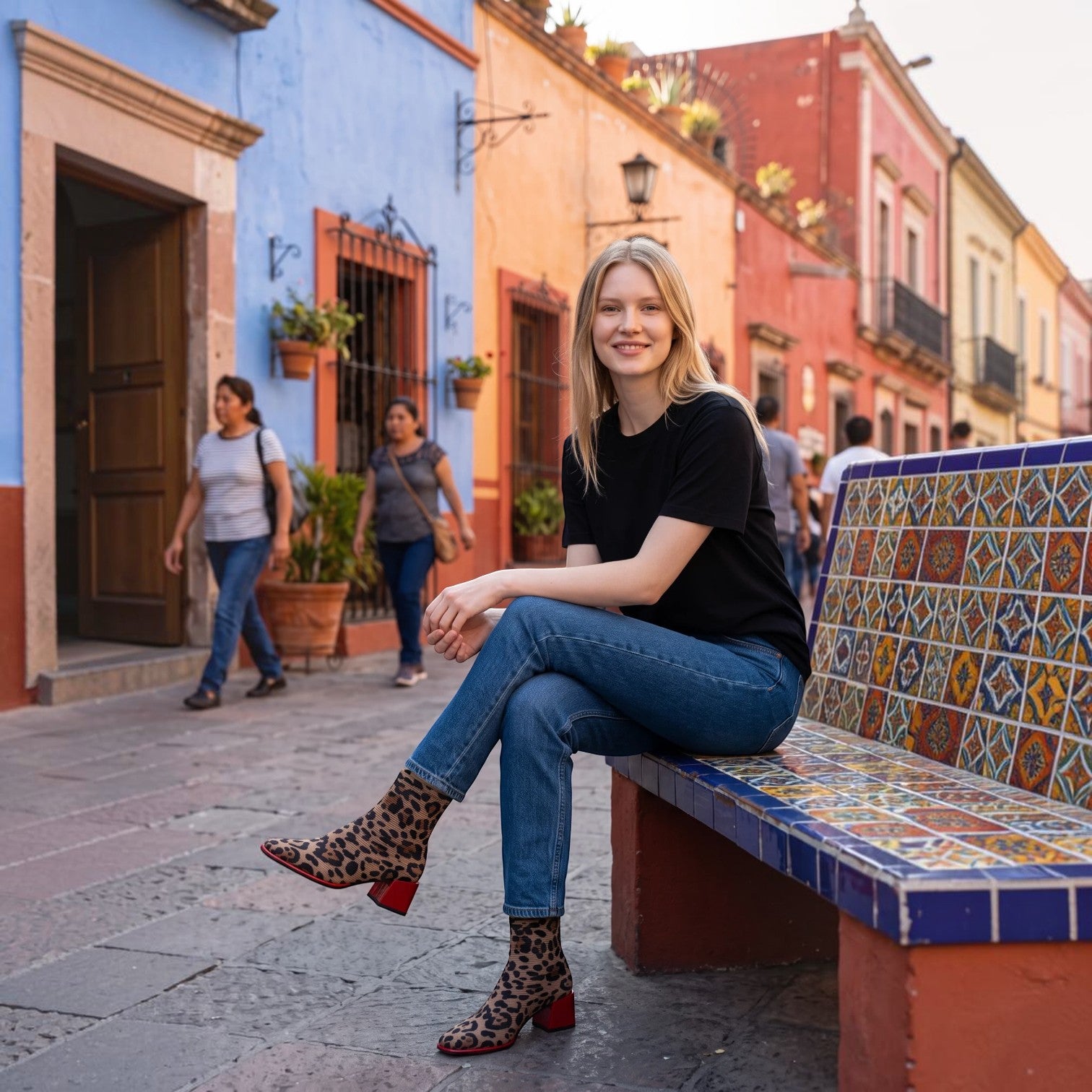 ShoeShop Gioseppo 80683 ankle boots in leopard print elastane with a red block heel, worn by a woman on a bench.