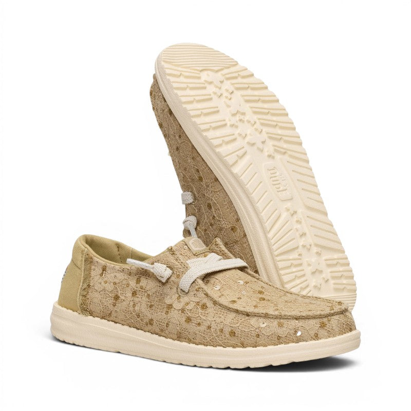 ShoeShop Hey Dude beige lace slip-on sneakers with white laces and a textured rubber sole.