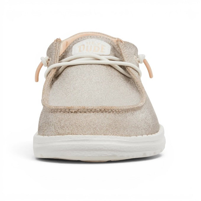 ShoeShop Hey Dude Wendy Metallic Sparkle slip-on shoe in shimmering beige textile with white elastic laces.