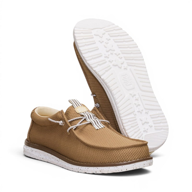 ShoeShop Hey Dude Wally mesh neutral brown slip-on shoes with white speckled soles and striped lace detail.