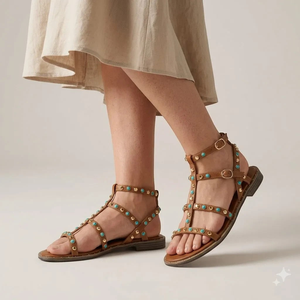ShoeShop Kharisma brown gladiator sandals with turquoise stone embellishments and gold studs on a model