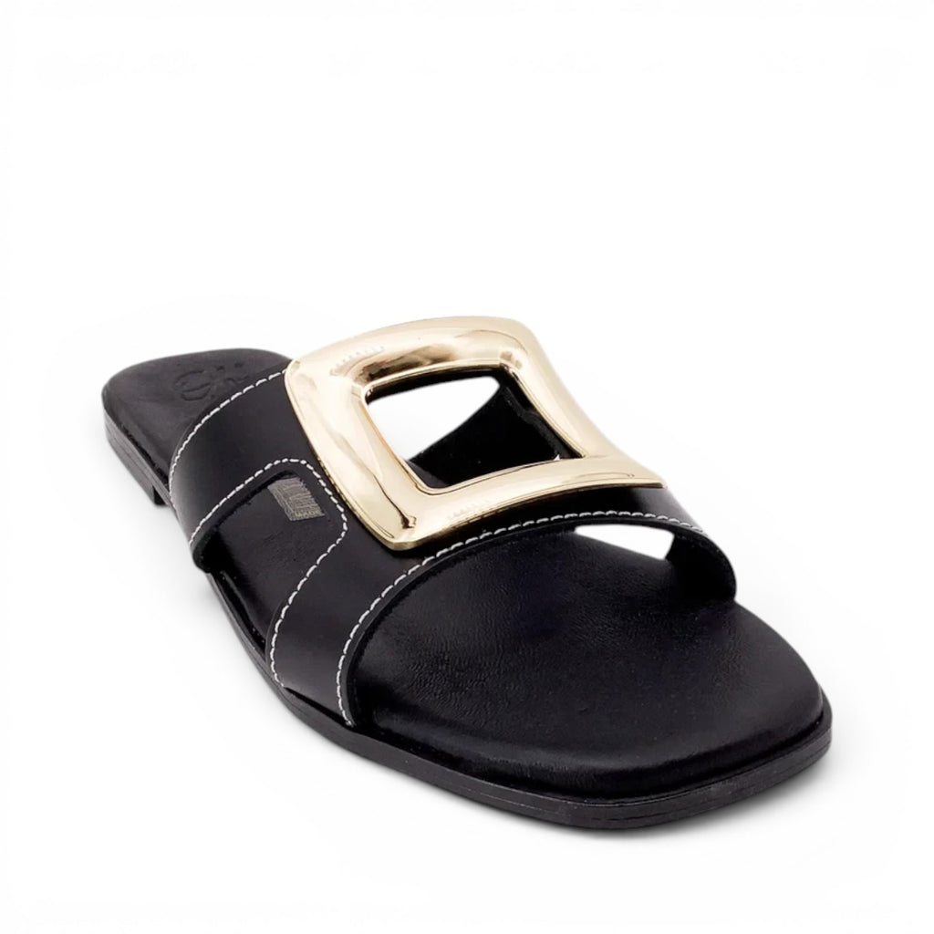 ShoeShop Oh My Sandals 5565 black flat slide sandals with a large gold square buckle and white contrast stitching.