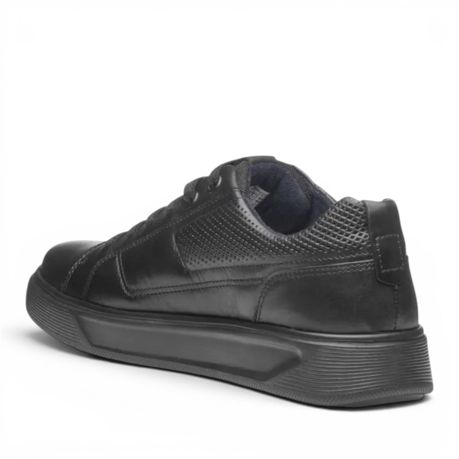 ShoeShop Pegada black leather sneaker with perforated side detail and thick rubber sole, rear view