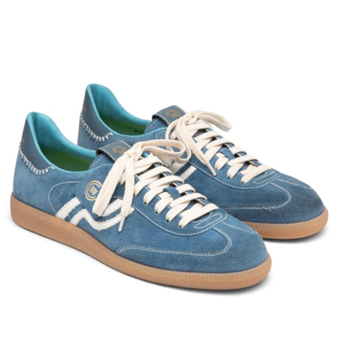 ShoeShop Primabase Polo light blue suede sneakers with white laces, gum rubber sole, and decorative stitching.