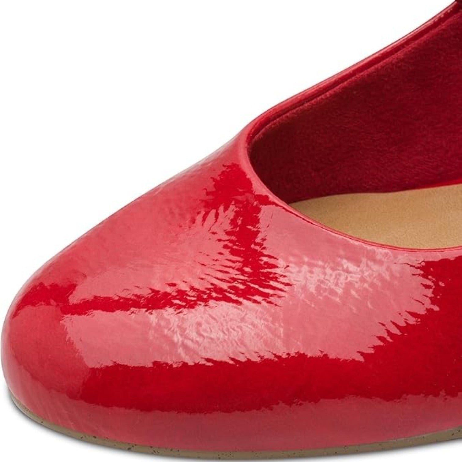 Close-up of a glossy red patent leather pump by ShoeShop, featuring a rounded toe and smooth finish.