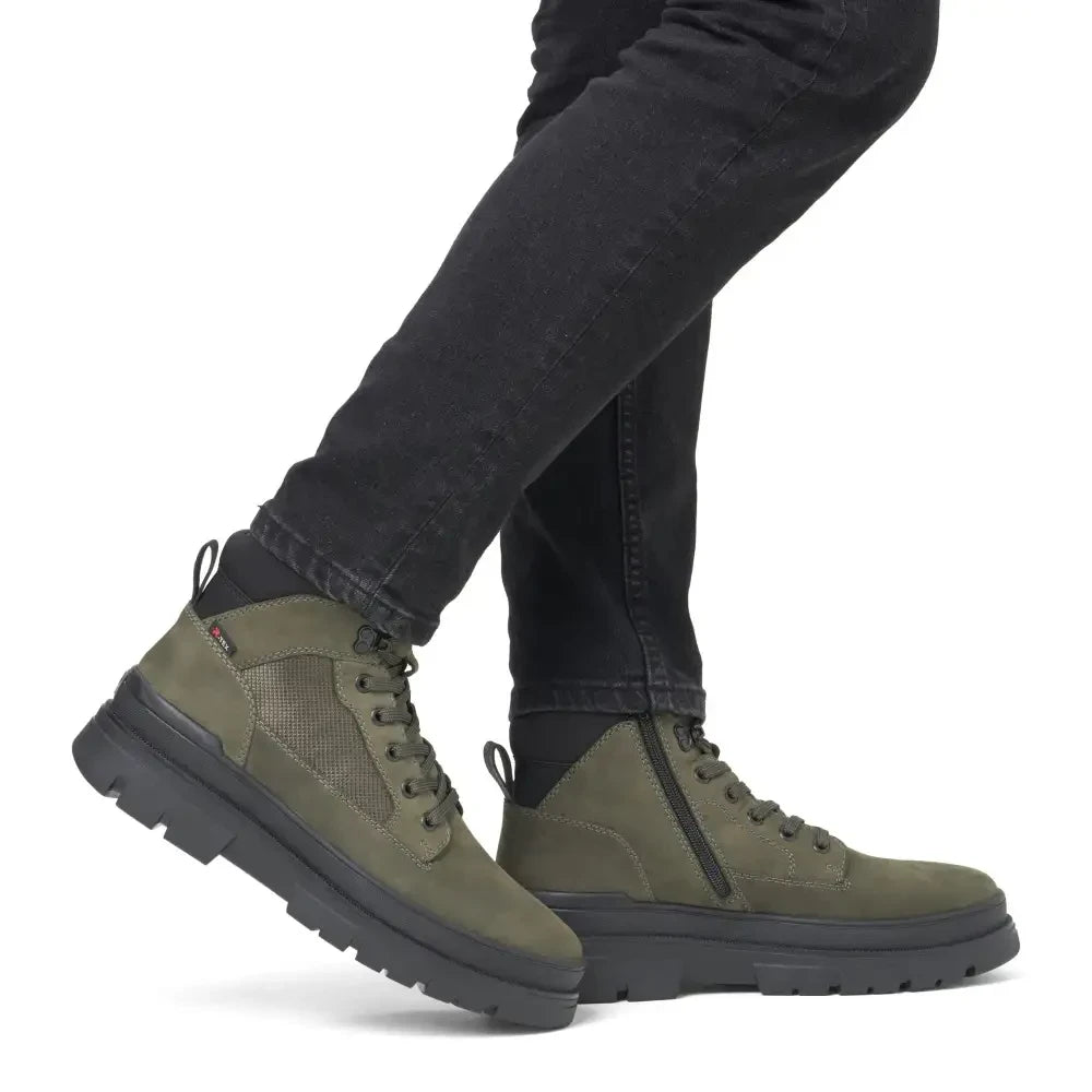 ShoeShop Rieker U1270-54 olive green lace-up ankle boots with side zip and chunky black lug sole on a model
