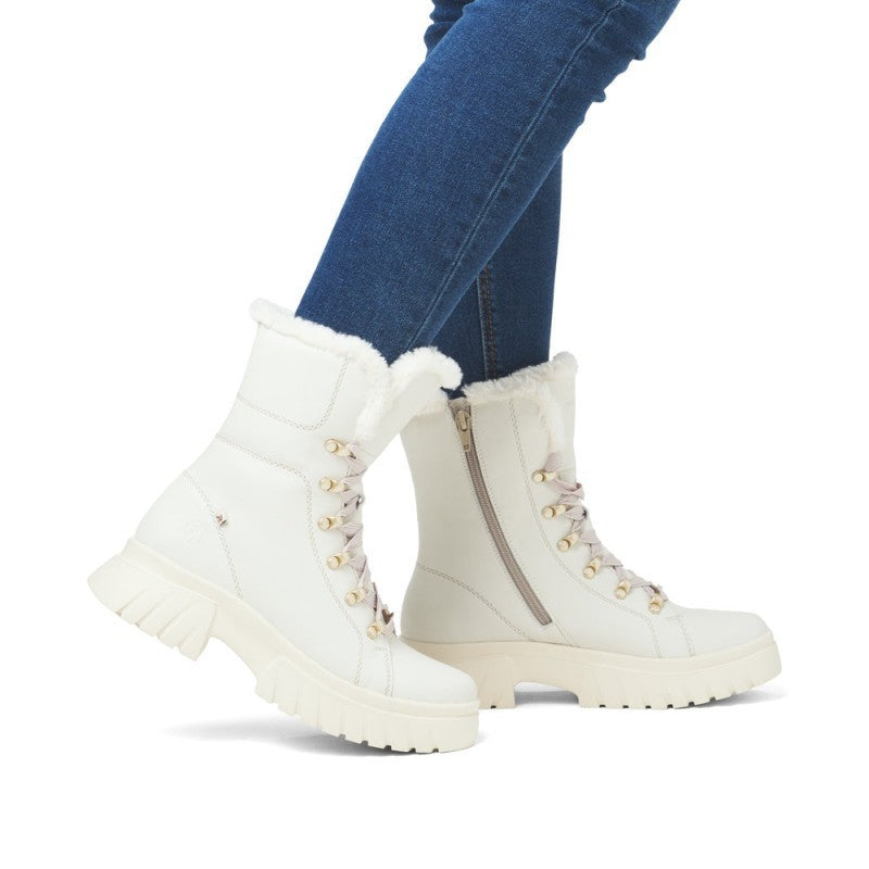 ShoeShop Rieker white leather winter boots with faux fur lining, lace-up front, and chunky rubber sole