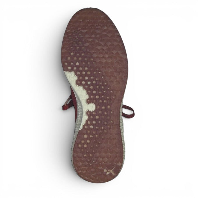 ShoeShop Tamaris sneaker showing the textured burgundy and white rubber outsole with a geometric grip pattern.
