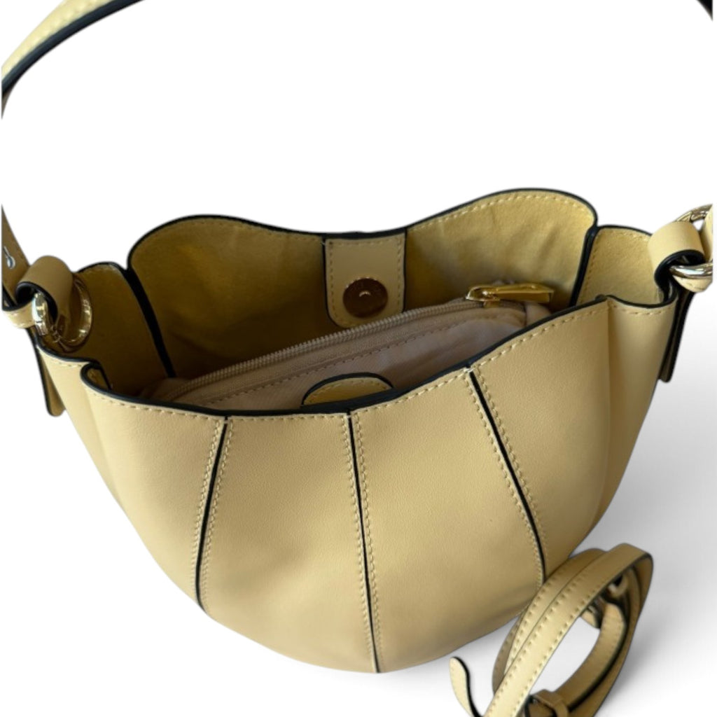 ShoeShop W216 pale yellow bucket bag with a structured shell design, gold-tone hardware, and an internal zip pocket.