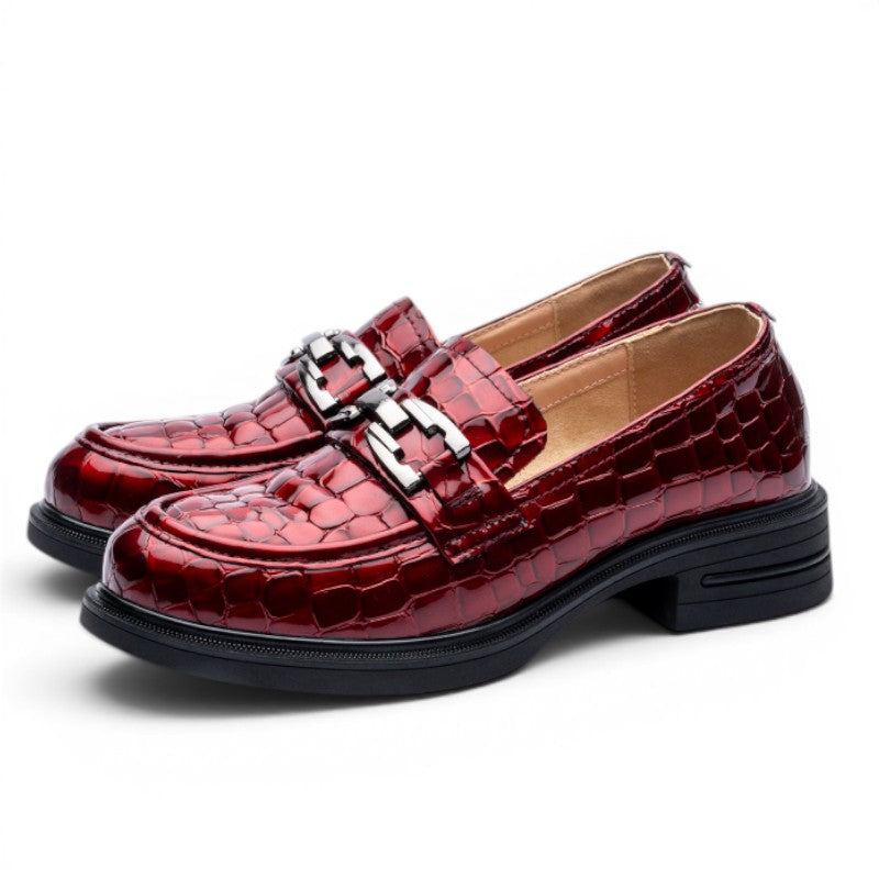 ShoeShopHere red patent leather crocodile-embossed loafers with silver buckle detail and rubber sole.