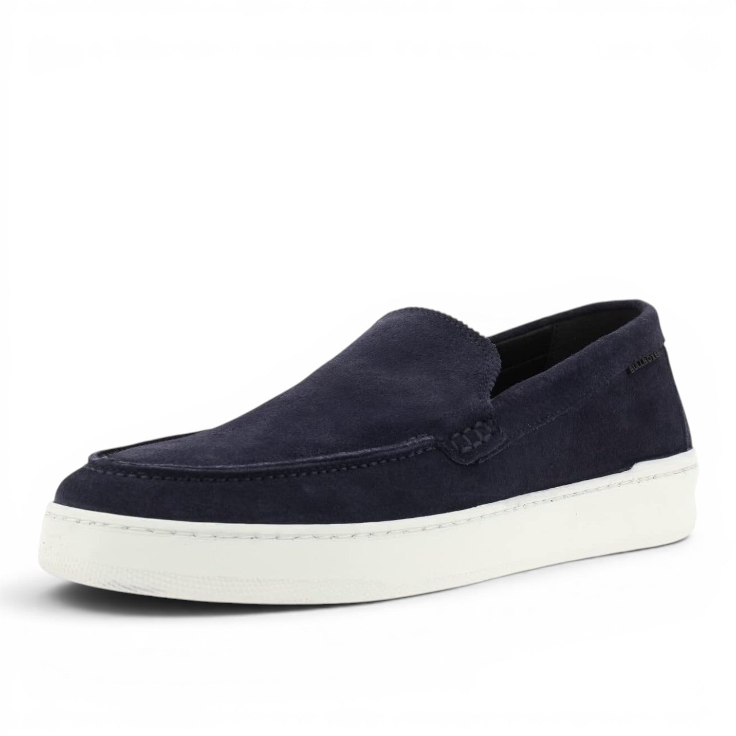 ShoeShop navy blue suede slip-on loafers with white sole and stitched detailing.
