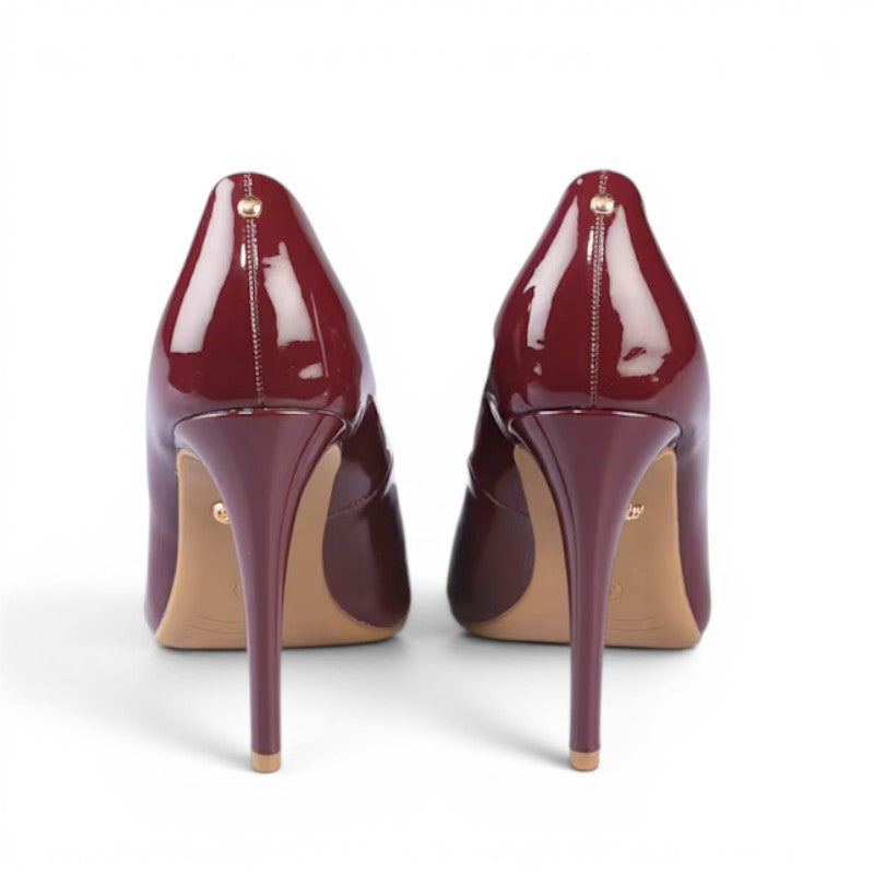 ShoeShop Sienna pump in glossy burgundy patent leather with a stiletto heel and gold accent.