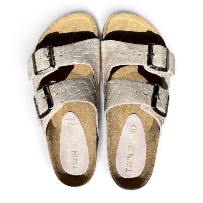 ShoeShop Twin Island white leather crocodile-embossed double buckle slide sandals with adjustable straps.