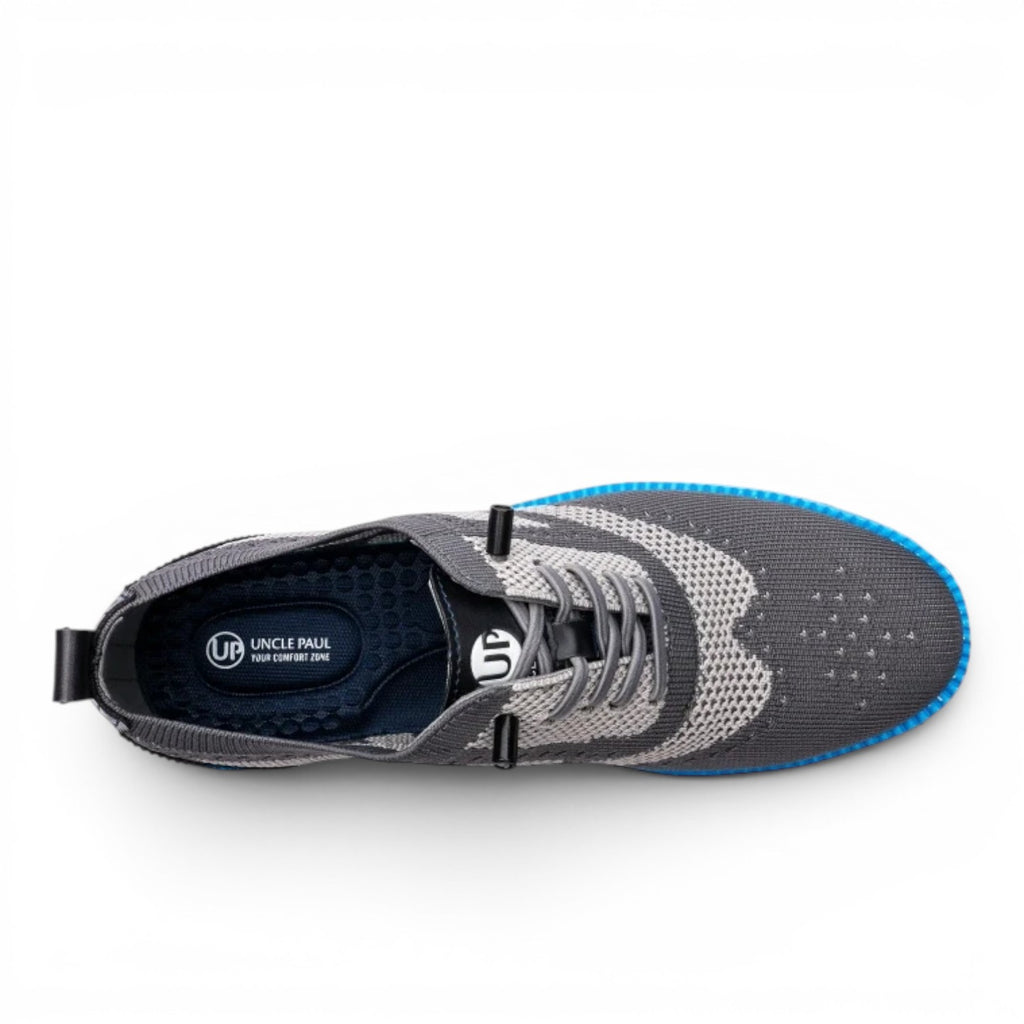 Uncle Paul Juhan men's grey knit sneakers with blue sole accents and brogue-style details. Breathable, elastic fabric.