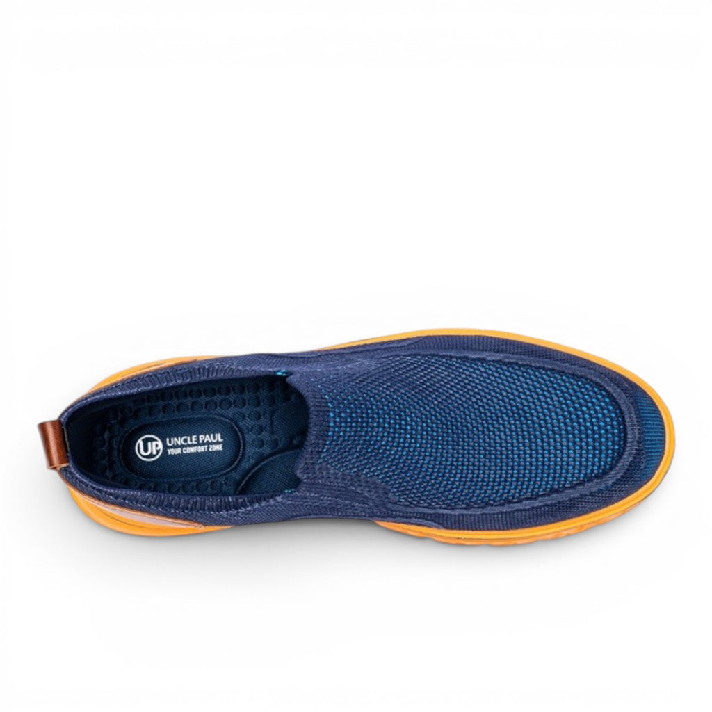 Uncle Paul JUSS navy blue knit slip-on sneakers with orange sole and brown heel tab.